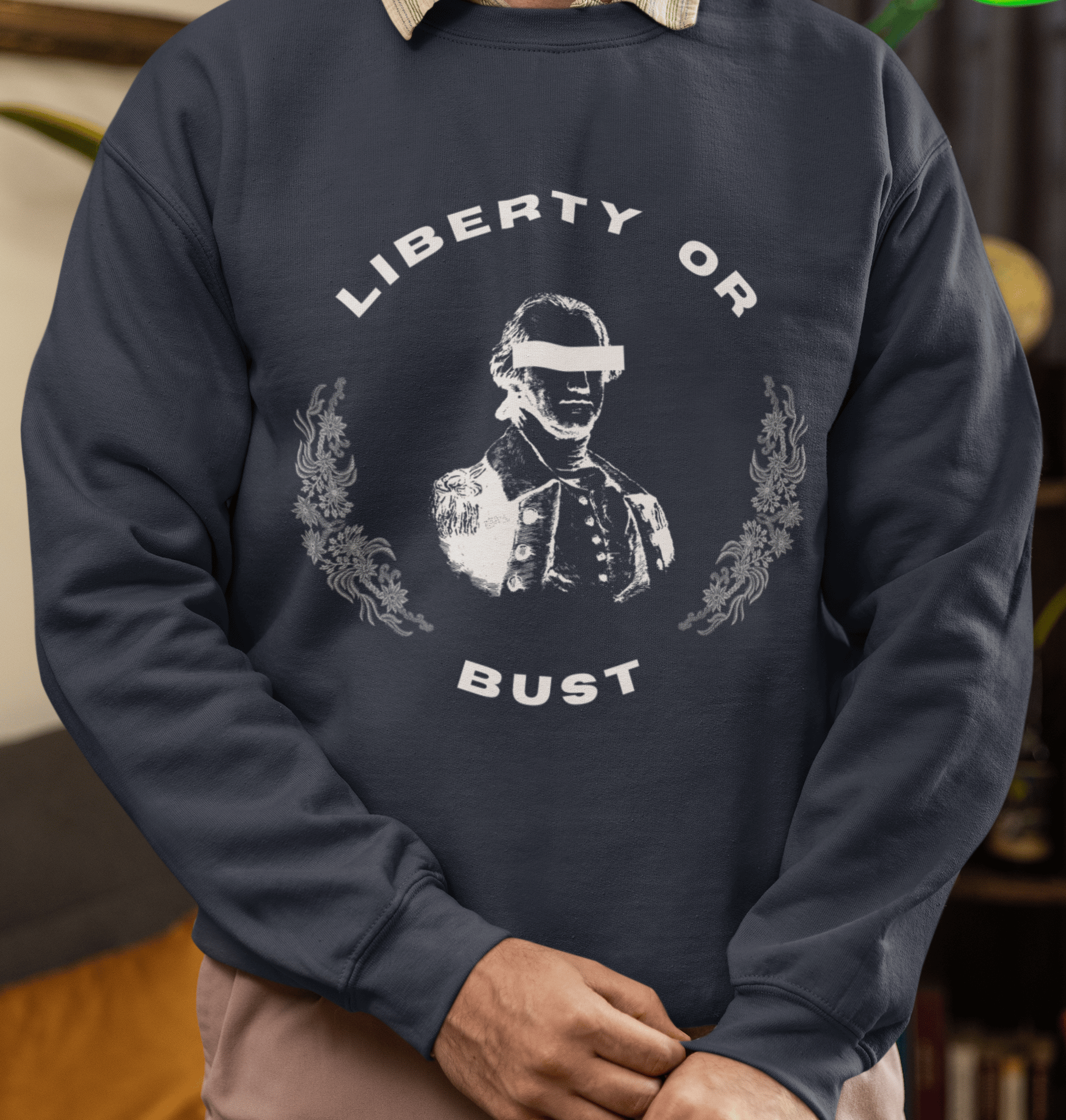 Person wearing a navy blue sweatshirt with 'Liberty or Bust' graphic design.